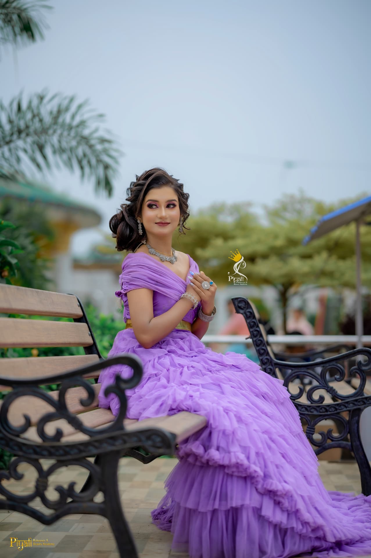 Client styled in a lavender ruffled gown with soft curls for an outdoor photoshoot